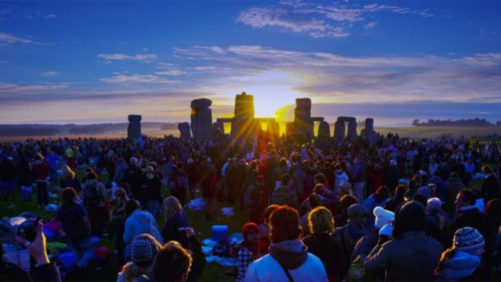 "Friends enjoying summer solstice party with lights and music"