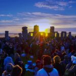 "Friends enjoying summer solstice party with lights and music"